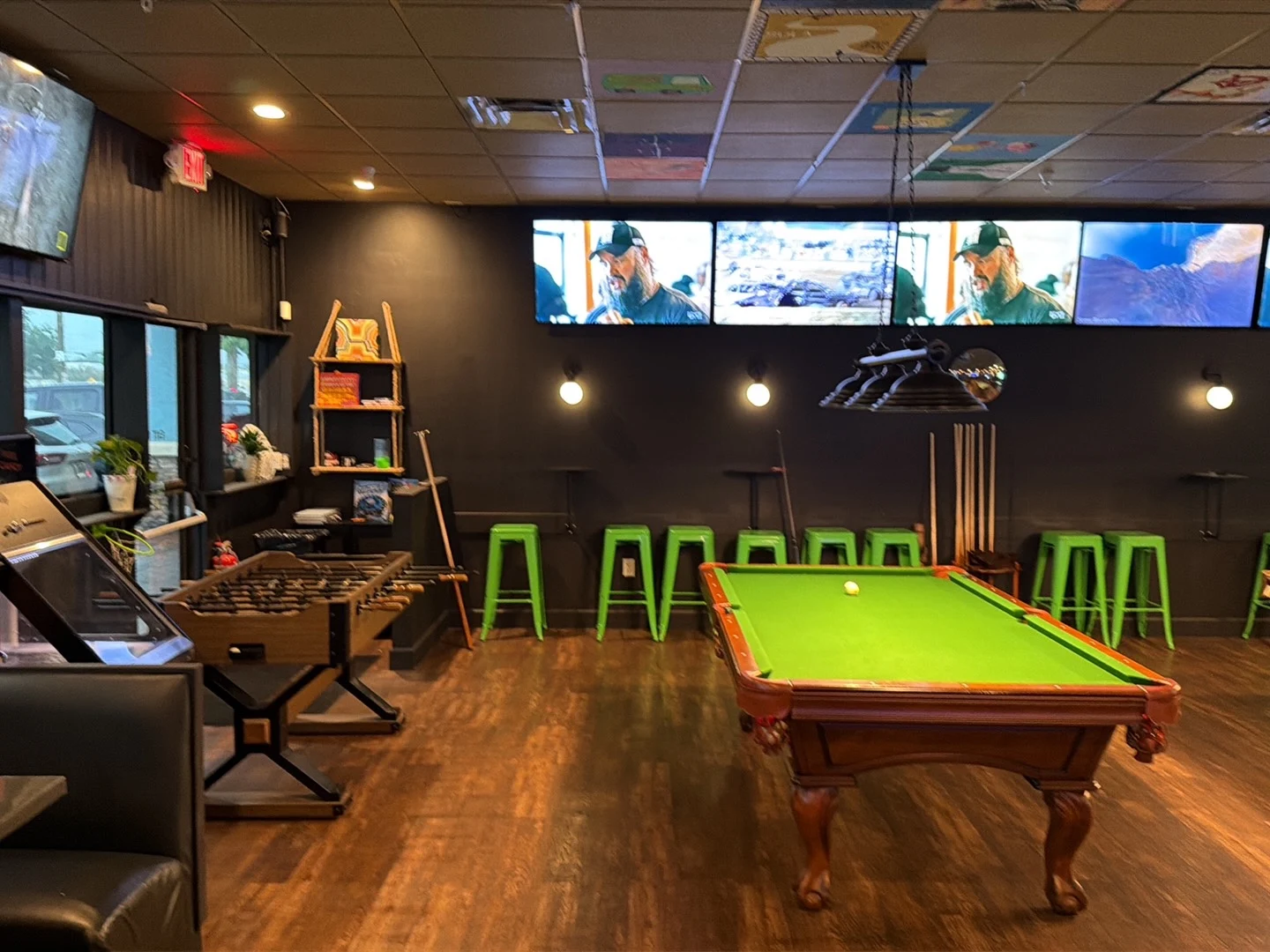Pool tables and foosball area inside Radical Root Kava Bar