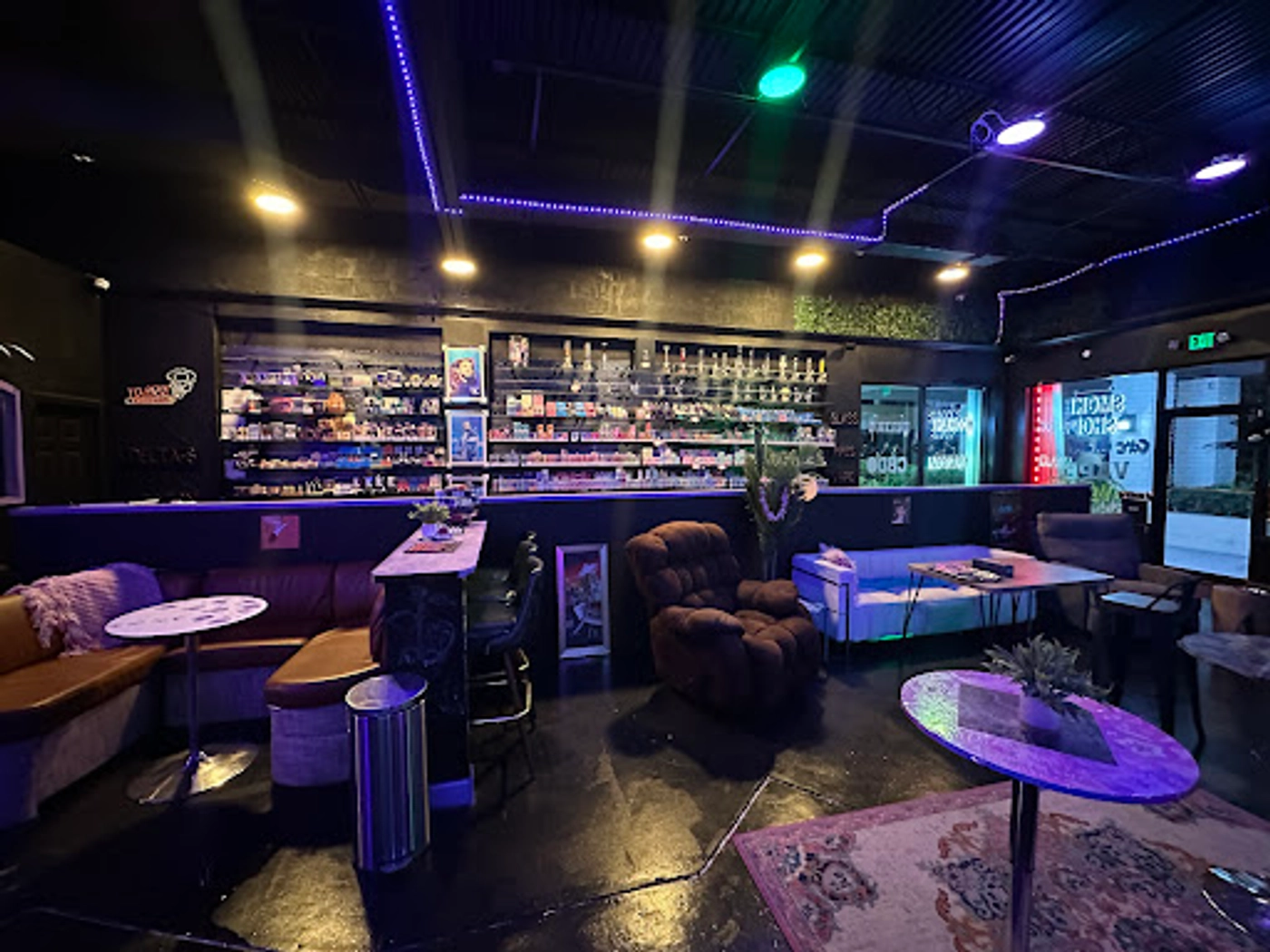 The bar and lounge at The Social Blend under purple and green neon